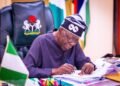 President Bola Tinubu signing the executive order ending NNPC’s 30% oil revenue cuts.